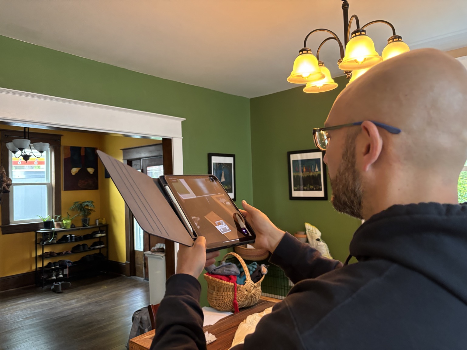 OCD HVAC technician working in an attic near HVAC ductwork and diagnostic equipment.